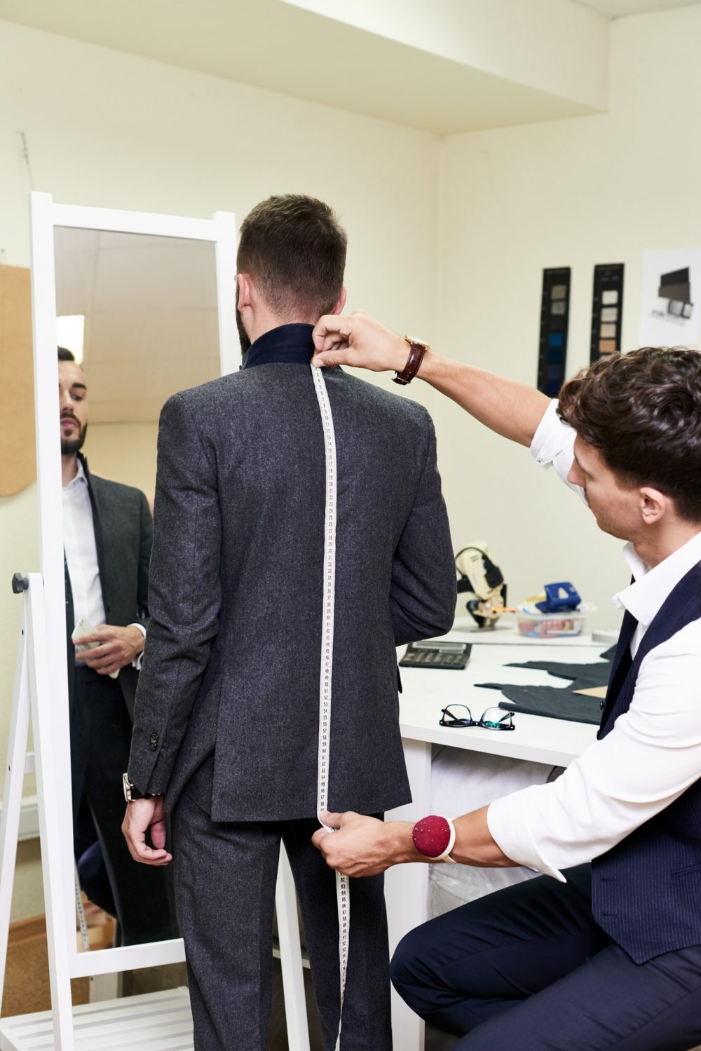 taking measurement for mens 3 piece suit